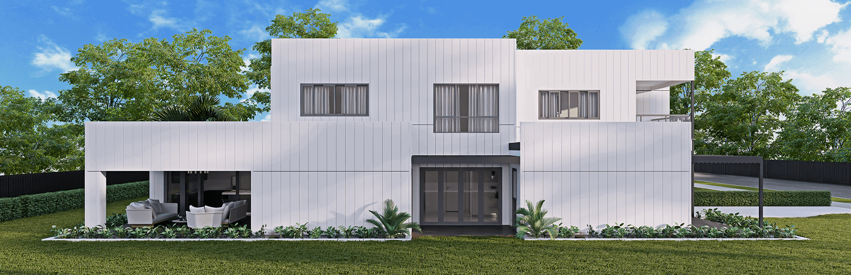 A modern, two-story house with white exterior panels, gray windows, and a flat roof stands amidst lush greenery. The front yard features neatly trimmed grass and low shrubs. An open garage area with outdoor seating is visible on the left side. The sky is sunny and clear.