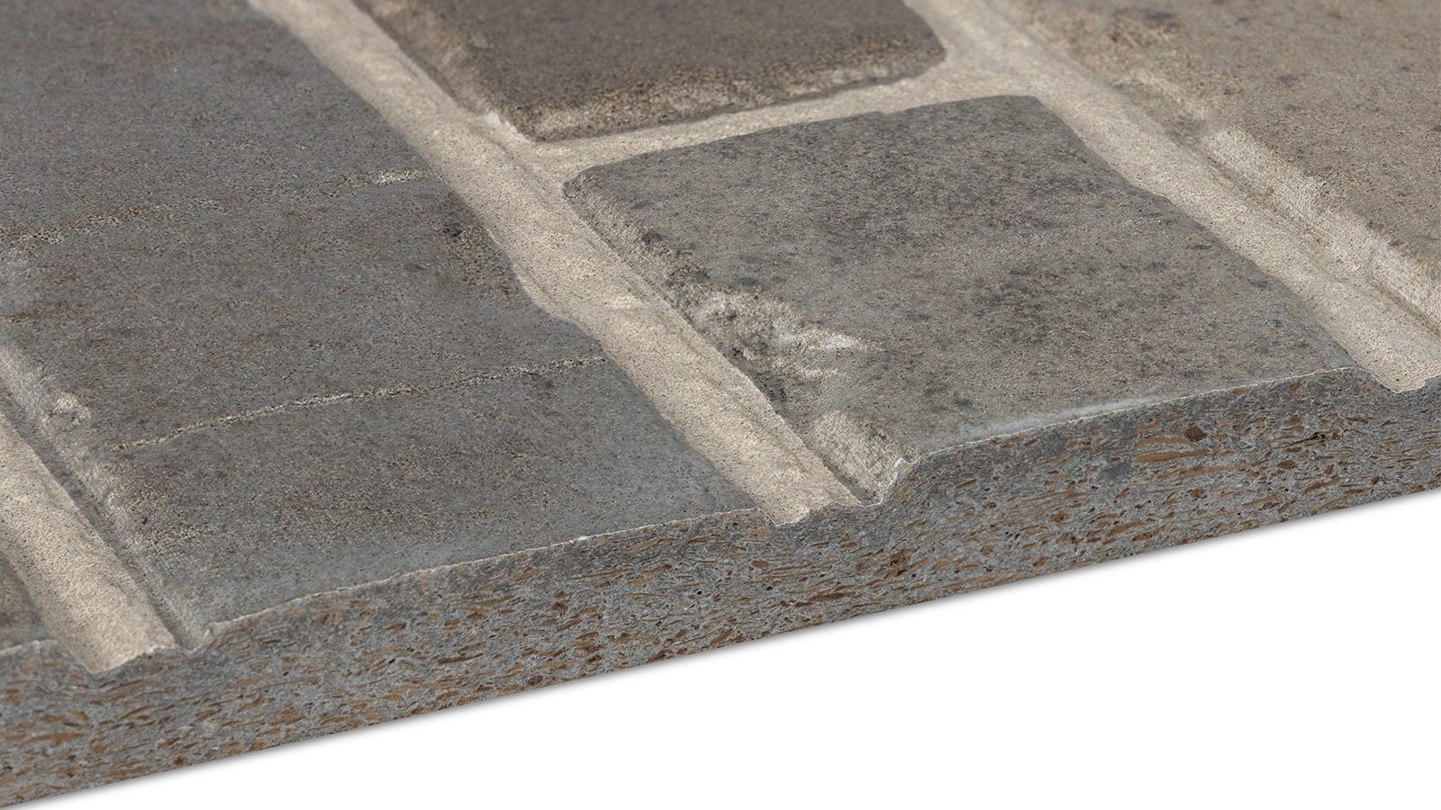 A close-up view of a rustic brick wall showing a texture with gray bricks and light-colored mortar lines. The edges of the bricks have a worn and weathered appearance, providing a rugged look to the masonry work.