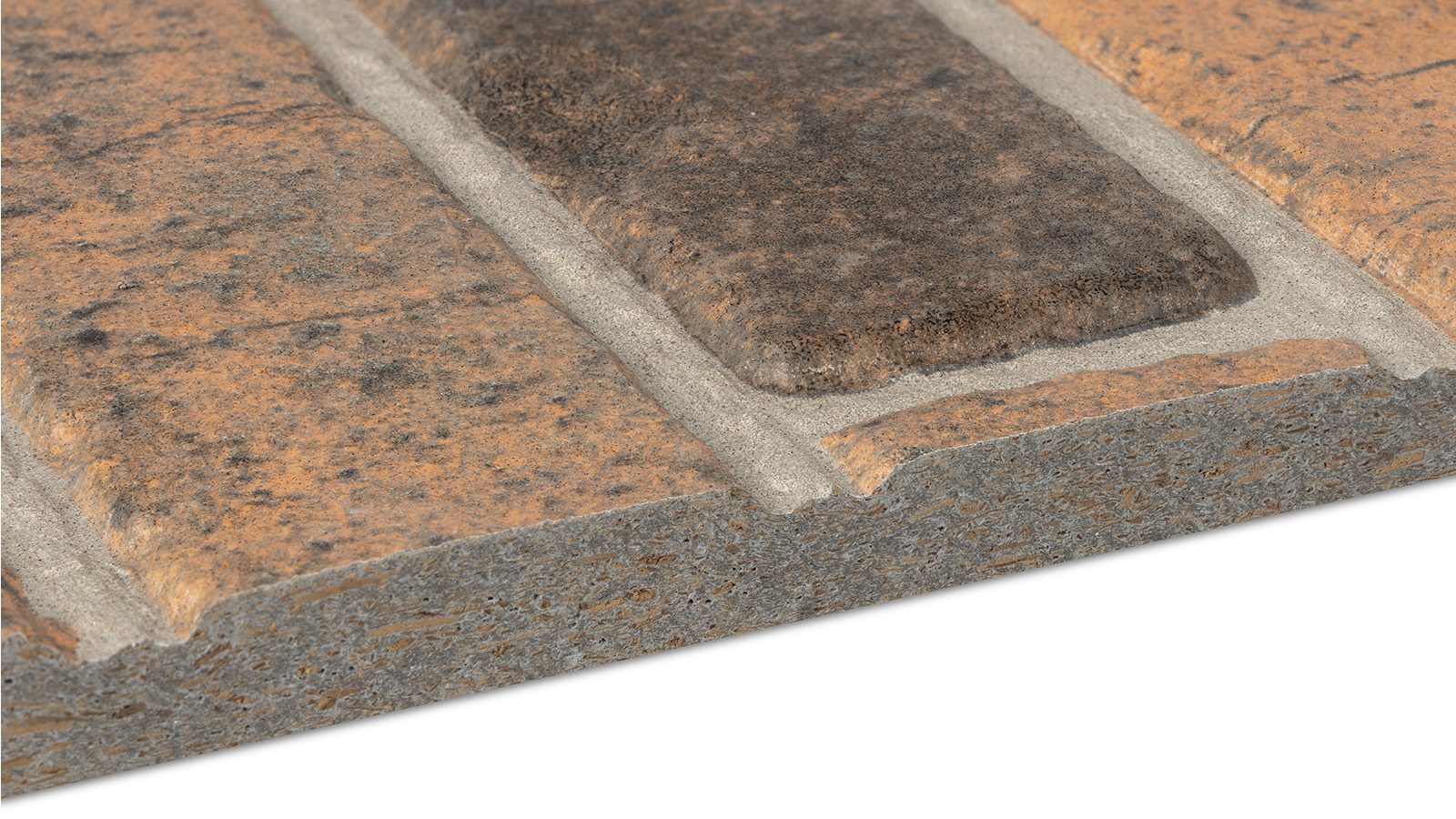 Close-up of a rectangular piece of faux brick wall cladding. The cladding has a textured surface with alternating light brown and dark brown rectangular sections separated by grooves mimicking mortar lines. The edge shows the thickness of the panel.