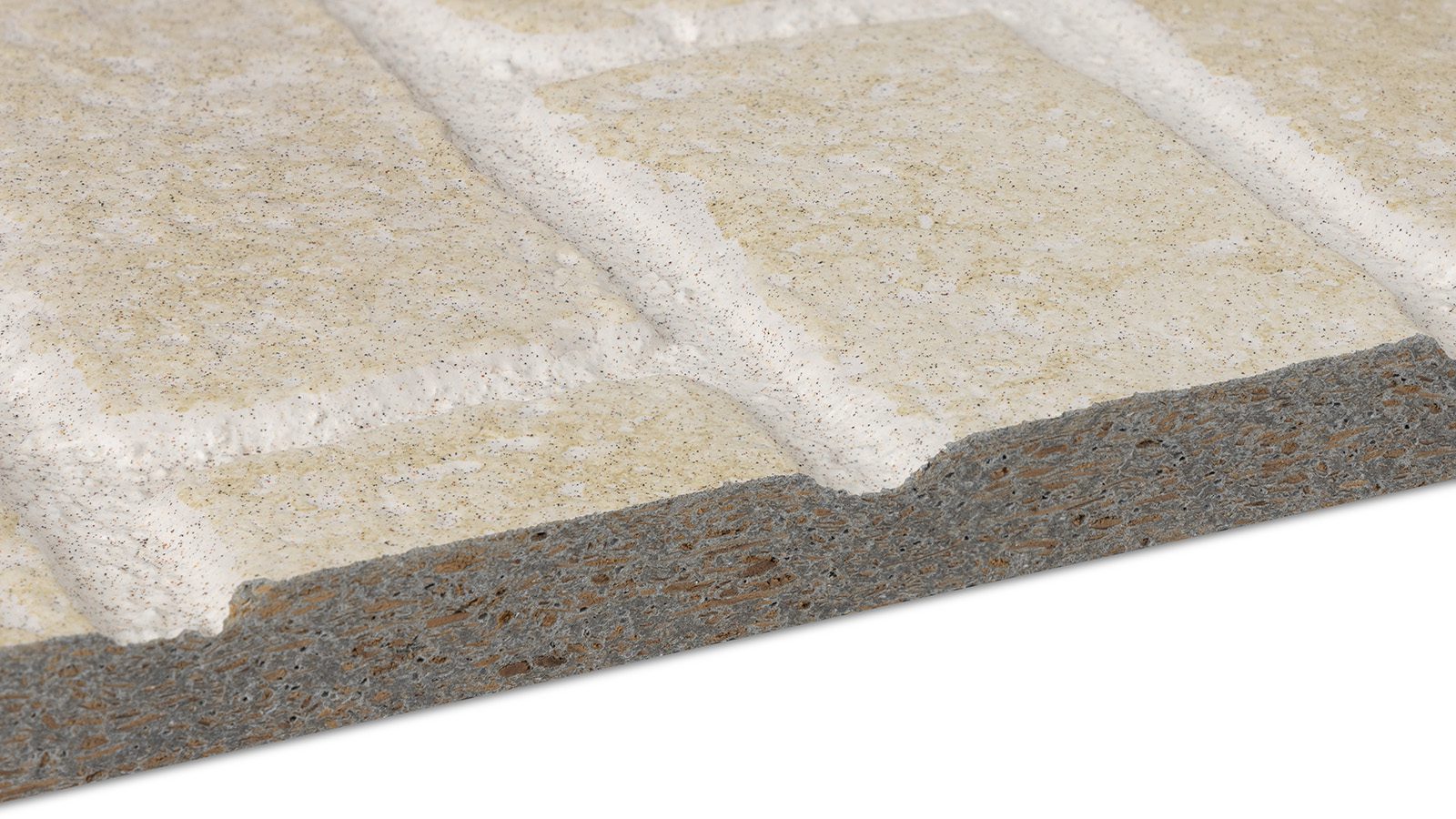 Close-up of a tile or stone slab with a rough edge. The surface has a pale, sandy texture with rectangular brick-like sections separated by white grout lines. The edge reveals a darker, composite material.