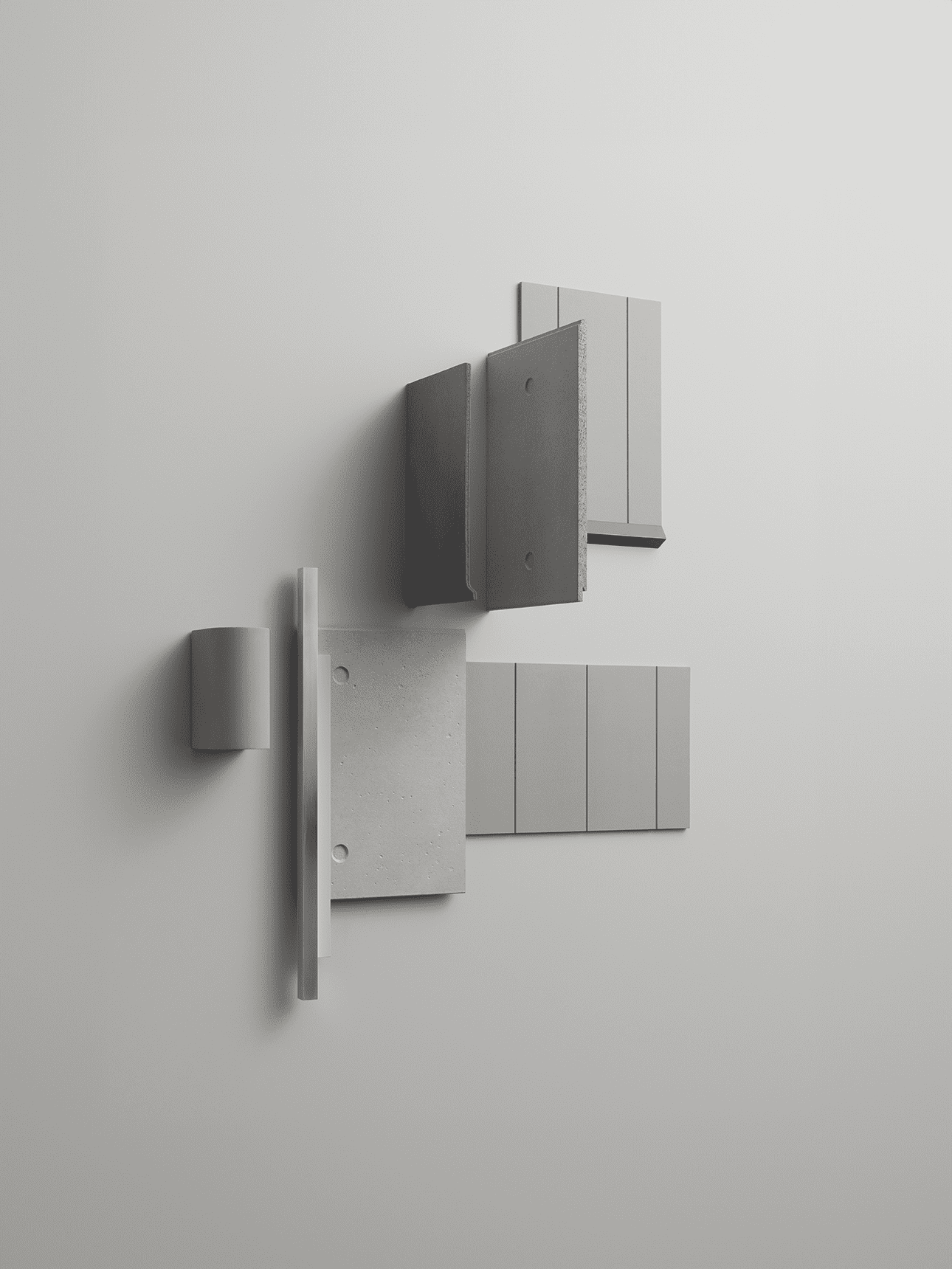 A minimalist arrangement of geometric tiles and blocks in neutral gray and beige tones mounted on a light gray wall, creating an abstract, modern composition.